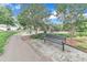 Community park area featuring a paved walking path, park bench and picnic tables at 151 Bridge St, Hillsborough, NC 27278