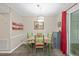 Charming dining room featuring a decorative light fixture, colorful furniture, and access to an outdoor deck at 151 Lake Pine Dr, Cary, NC 27511