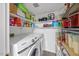 Organized laundry room with modern washer and dryer units, shelving, and plenty of storage space for household essentials at 151 Lake Pine Dr, Cary, NC 27511