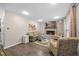 Inviting living room with a brick fireplace, comfortable seating, and a mounted television for entertainment at 151 Lake Pine Dr, Cary, NC 27511