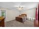 Spacious main bedroom featuring wood floors and a ceiling fan with natural light from the window at 151 Lake Pine Dr, Cary, NC 27511