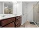 Well-lit bathroom featuring a double sink vanity with granite countertop and tiled shower at 1728 Shady Oaks Dr, Wendell, NC 27591