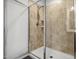 Modern bathroom with tiled shower featuring glass doors, a shower head and built in shelves at 1728 Shady Oaks Dr, Wendell, NC 27591