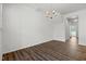 Minimalist dining room with hard surface floors, chandelier, and bright, neutral walls at 1728 Shady Oaks Dr, Wendell, NC 27591