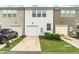 Stylish townhouse featuring a one car garage, modern siding, and manicured landscaping at 1728 Shady Oaks Dr, Wendell, NC 27591