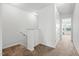 Bright hallway and staircase featuring neutral carpeting and crisp white walls and trim at 1728 Shady Oaks Dr, Wendell, NC 27591