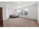 Large main bedroom featuring neutral carpeting, crisp white walls, and abundant natural light at 1728 Shady Oaks Dr, Wendell, NC 27591
