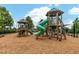 Community playground with a wooden playset, slides, and mulch ground covering at 1728 Shady Oaks Dr, Wendell, NC 27591