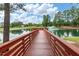 A picturesque pond with a fountain and wooden pier, surrounded by lush trees at 1728 Shady Oaks Dr, Wendell, NC 27591