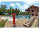 Community pool area with lounge chairs, umbrellas, a slide, and a clubhouse for residents at 1728 Shady Oaks Dr, Wendell, NC 27591