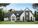 Striking white brick home with black trim, manicured lawn, and professional landscaping creates an inviting curb appeal at 1808 Stream Manor Ct, Wake Forest, NC 27587