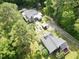 Expansive aerial view showcasing multiple homes and wooded areas of the lush property at 183 Birnamwood Dr, Chapel Hill, NC 27516