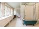 Bright bathroom featuring a classic clawfoot tub and plentiful natural light from the windows at 183 Birnamwood Dr, Chapel Hill, NC 27516