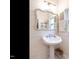 Charming bathroom features a pedestal sink, decorative mirror, and shiplap walls for a clean, classic look at 183 Birnamwood Dr, Chapel Hill, NC 27516