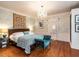 Elegant bedroom featuring hardwood floors, a chandelier, and stylish decor at 183 Birnamwood Dr, Chapel Hill, NC 27516