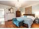 Comfortable bedroom with hardwood floors, a chandelier, and a decorative fireplace mantel at 183 Birnamwood Dr, Chapel Hill, NC 27516