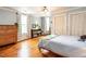 Comfortable bedroom with wooden floors, neutral walls, a ceiling fan, windows, and a dresser at 183 Birnamwood Dr, Chapel Hill, NC 27516