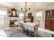 Charming dining room features a fireplace, chandelier lighting, and a classic hutch for storage at 183 Birnamwood Dr, Chapel Hill, NC 27516