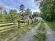 Charming home with a well-maintained lawn and a gravel driveway at 183 Birnamwood Dr, Chapel Hill, NC 27516