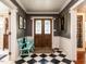 Traditional foyer boasts a checkered floor, beautiful doors, and elegant wainscoting at 183 Birnamwood Dr, Chapel Hill, NC 27516