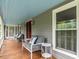 Charming front porch with a blue ceiling, featuring comfortable seating and a view of the outdoors at 183 Birnamwood Dr, Chapel Hill, NC 27516