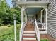 Inviting covered front porch with wooden flooring and ample seating offers a relaxing outdoor space at 183 Birnamwood Dr, Chapel Hill, NC 27516