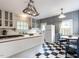 Charming kitchen with checkered floors, a center island, and a cozy breakfast nook by the windows at 183 Birnamwood Dr, Chapel Hill, NC 27516