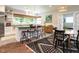 Open kitchen boasts an island with seating, stainless steel appliances, and natural light from large windows at 183 Birnamwood Dr, Chapel Hill, NC 27516