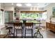 Bright kitchen featuring a large island with seating, stainless steel appliances, and ample natural light at 183 Birnamwood Dr, Chapel Hill, NC 27516