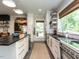 Modern kitchen with sleek cabinetry, stainless steel appliances, black countertops and natural light at 183 Birnamwood Dr, Chapel Hill, NC 27516