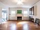 Bright living room with hardwood floors and a fireplace at 183 Birnamwood Dr, Chapel Hill, NC 27516