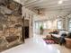 Bright living room with stone accent wall and a ceiling fan at 183 Birnamwood Dr, Chapel Hill, NC 27516