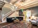 Stylish living room with a staircase featuring colorful stair risers and cozy seating with a view to another room at 183 Birnamwood Dr, Chapel Hill, NC 27516