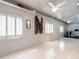 Bright and airy space with white walls and floors, equipped with workout machines and a ceiling fan at 183 Birnamwood Dr, Chapel Hill, NC 27516