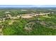 Expansive aerial view of a private estate with lush landscaping, a pond, and agricultural fields at 1852 Gwyn Rd, Burlington, NC 27217