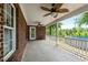 Back porch with brick siding, concrete flooring, and an outdoor ceiling fan at 1852 Gwyn Rd, Burlington, NC 27217