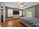Comfortable bedroom with hardwood floors, a ceiling fan, and a door leading to the deck at 1852 Gwyn Rd, Burlington, NC 27217