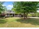 Charming brick home with inviting front porch and well-manicured lawn and a convenient covered parking area at 1852 Gwyn Rd, Burlington, NC 27217