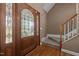 Welcoming foyer with hardwood floors, elegant staircase, and decorative glass front door, creating a warm first impression at 1852 Gwyn Rd, Burlington, NC 27217