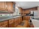 Traditional kitchen boasts wood cabinets, granite counters, and stainless steel appliances at 1852 Gwyn Rd, Burlington, NC 27217