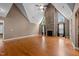 Spacious living room with stone fireplace, high ceilings, and hardwood floors, offering a blank canvas for personalization at 1852 Gwyn Rd, Burlington, NC 27217