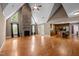 Open-concept living room with hardwood floors, stone fireplace, and seamless flow to the kitchen and dining areas at 1852 Gwyn Rd, Burlington, NC 27217