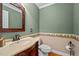Stylish powder room featuring decorative wallpaper border and a decorative framed mirror at 1852 Gwyn Rd, Burlington, NC 27217