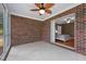 Enclosed sunroom with brick wall details and a view into a bedroom with a ceiling fan at 1852 Gwyn Rd, Burlington, NC 27217