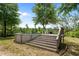 An above-ground pool surrounded by lush greenery and stairs at 1852 Gwyn Rd, Burlington, NC 27217