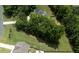 An aerial perspective reveals an expansive green lot with mature trees offering seclusion and a serene atmosphere at 20 Scotland Dr, Youngsville, NC 27596
