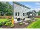Expansive backyard features a patio, screened in porch, lush lawn and manicured landscaping at 20 Scotland Dr, Youngsville, NC 27596