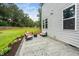 Beautiful backyard patio featuring comfortable seating, a fire pit, and professionally landscaped garden beds at 20 Scotland Dr, Youngsville, NC 27596