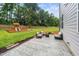 Spacious backyard featuring a playset, comfortable seating around a fire pit, and beautiful landscaping at 20 Scotland Dr, Youngsville, NC 27596