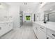 Luxurious bathroom with separate vanities, a soaking tub, and a glass enclosed shower at 20 Scotland Dr, Youngsville, NC 27596